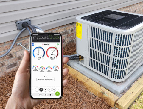 A technician is using a mobile phone with the MeasureQuick app displayed. He is holding in front of an outdoor AC unit. Caption: Air Conditioning and Heating Service and Repair